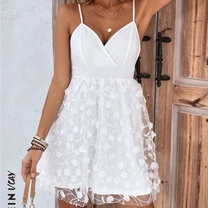 White summer dress with floral design and v-neck.
